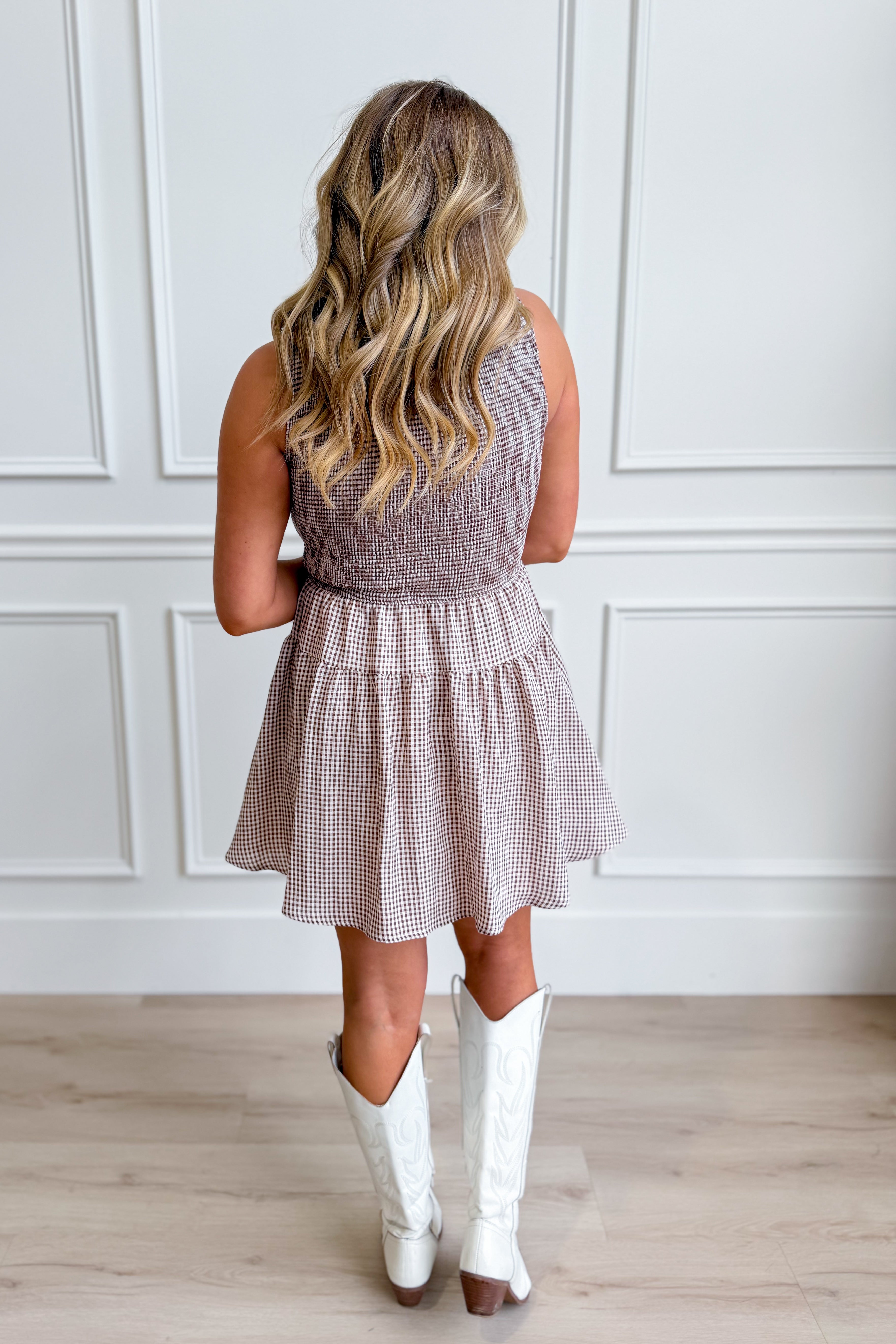 Liz Brown gingham smocked sleeveless dress by BLU PEPPER, featuring a fitted bodice and flowy skirt in a classic checkered pattern.