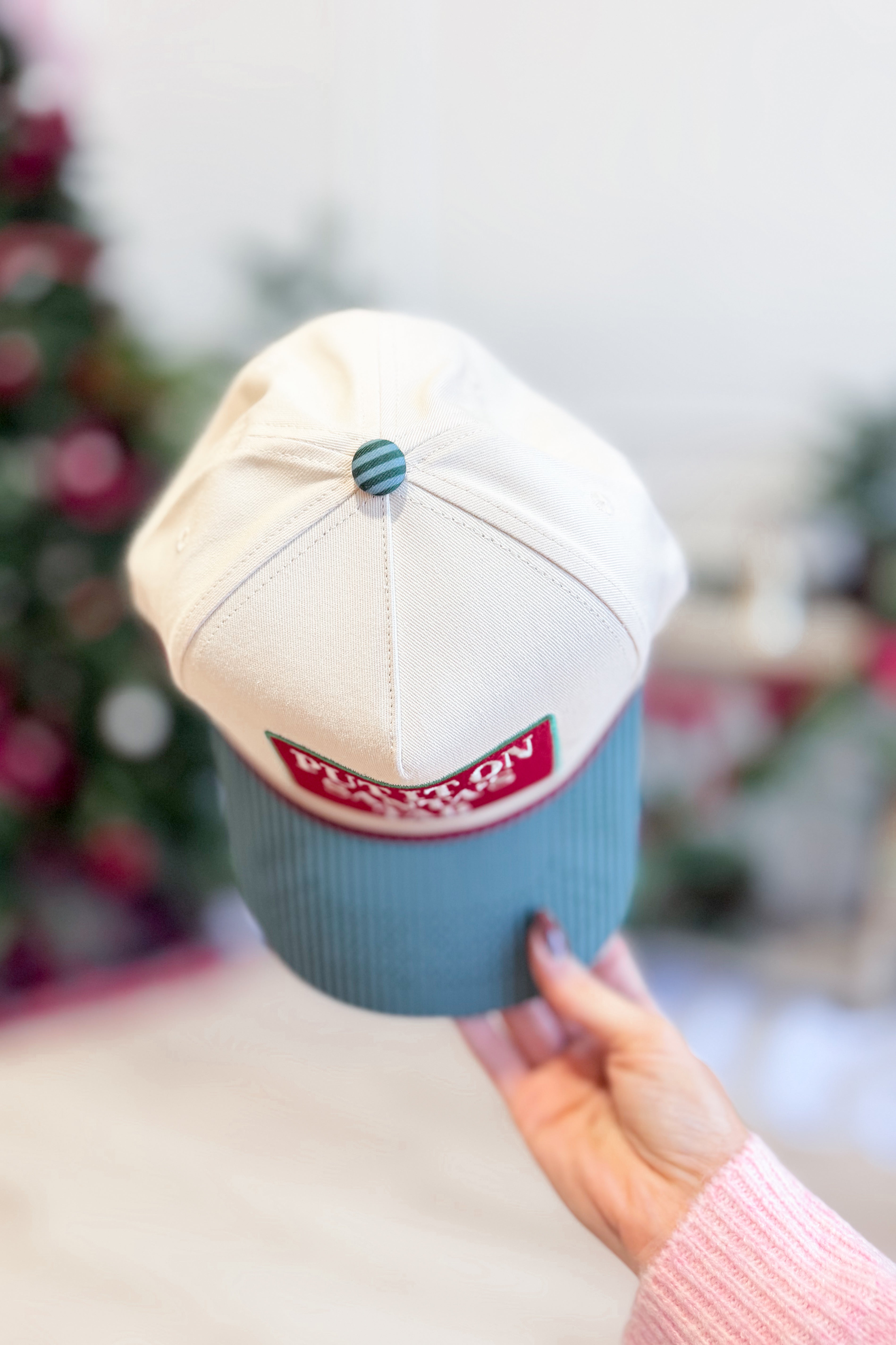 Put It On Santa's Tab Hat from SUMMER TEES, a festive red and white holiday hair accessory with a playful Santa theme.
