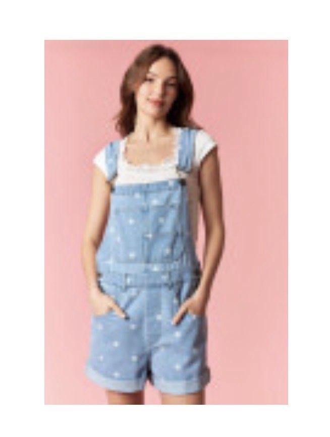 PEACH LOVE Holly polka dot denim overall romper displayed on a hanger, featuring a playful polka dot pattern and adjustable straps.