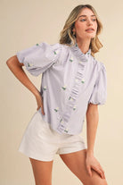 &MERCI Denna floral embroidery striped ruffled button-down top, stylish dressy blouse with floral details and ruffles.