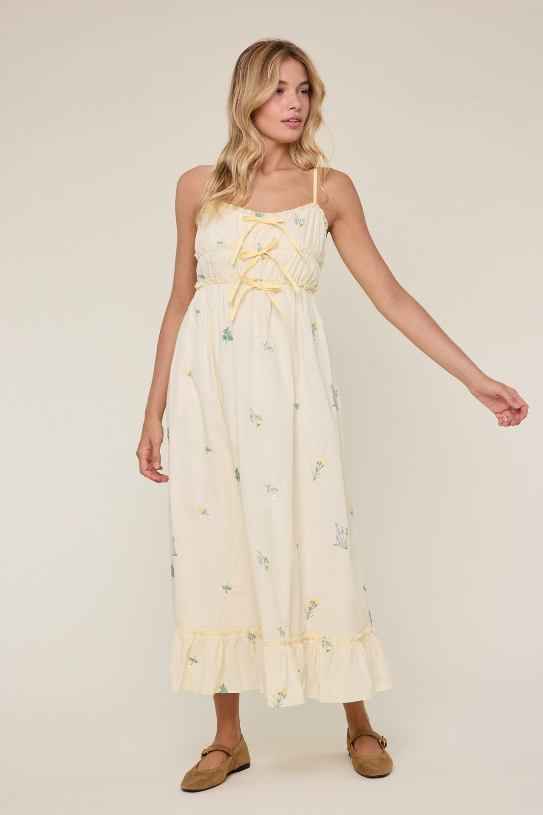 Avery Triple Bow Floral Midi Dress by WISHLIST featuring a flowy fabric, floral print, and elegant bow details.