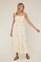 Avery Triple Bow Floral Midi Dress by WISHLIST featuring a flowy fabric, floral print, and elegant bow details.