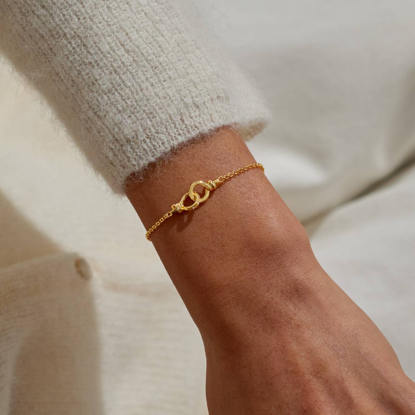 A LITTLES & CO Evermore Linked Knot bracelet featuring a delicate silver knot design on a chain.