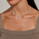 A LITTLES & CO Evermore Circle T Bar 16-inch necklace featuring a sleek T-shaped pendant on a delicate chain.
