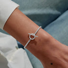 A LITTLES & CO Evermore Circle T Bar bracelet with sleek metal design and minimalist style, displayed on a neutral background.