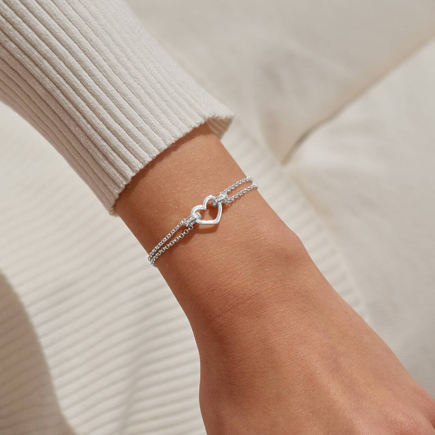 A LITTLES & CO Evermore Heart Bracelet featuring a delicate heart charm on a silver chain jewelry piece.