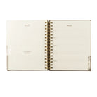 Undated 12-month planner by HOSANNA REVIVAL with a minimalist cover design, ideal for organizing schedules and appointments.