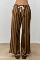 Kimmy Brown Striped Drawstring Pants by BAEVELY, featuring a relaxed fit with brown and white stripes and adjustable drawstring waist.