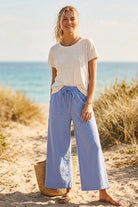 SEWN AND SEEN Benny Blue Polka Dot Wide Leg Pants with high waist and flowing fabric, shown on a model.