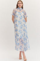 ENTRO Ollie floral printed short sleeve midi dress displayed on a hanger, showcasing its vibrant floral pattern and elegant design.