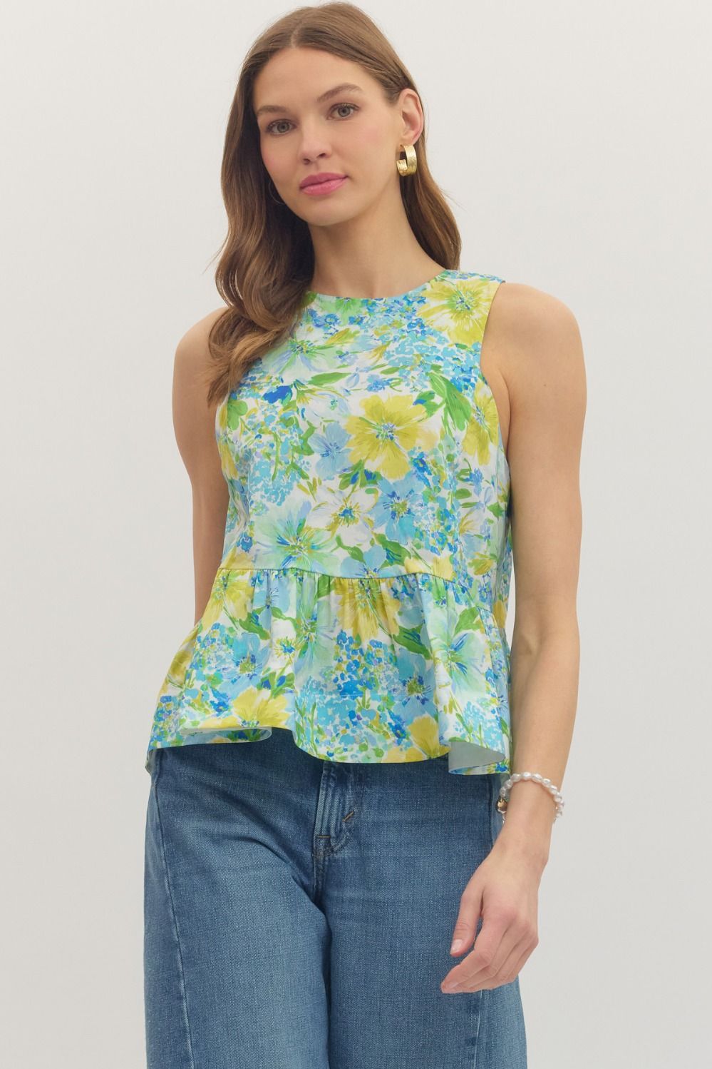 Floral Jenna sleeveless peplum top by ENTRO, casual 105 top with a fitted bodice and vibrant floral pattern.
