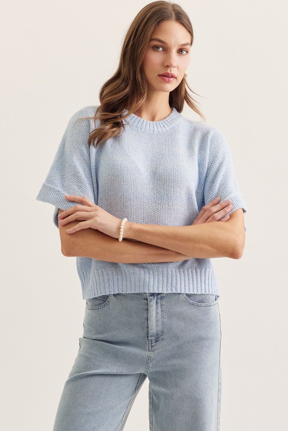 Light blue Brianna spring knitted short sleeve top by ENTRO, featuring a cozy, stylish design for warm weather wear.