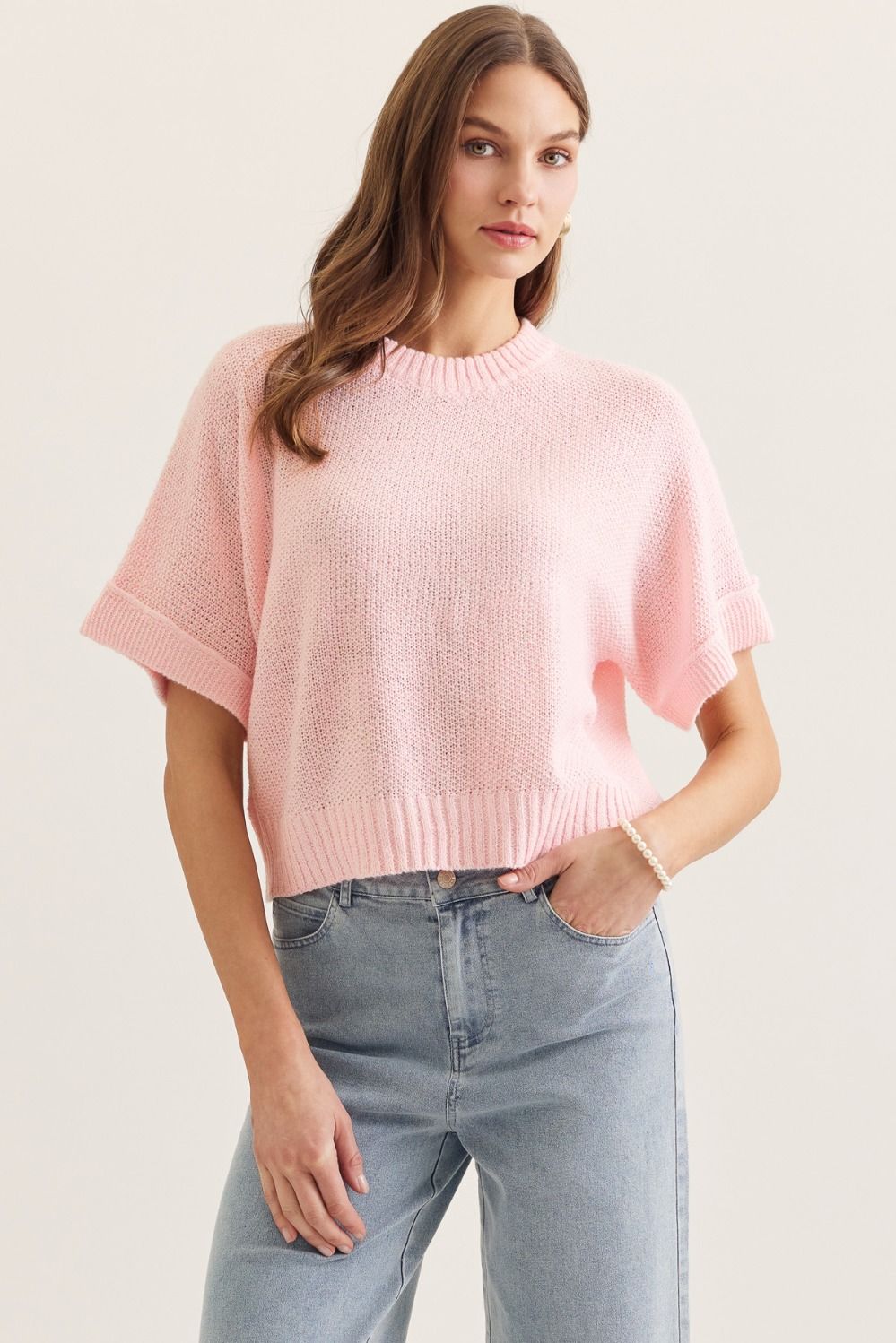 Pink Brianna Spring Knitted Short Sleeve Top by ENTRO, a stylish lightweight sweater for spring, shown on a model.