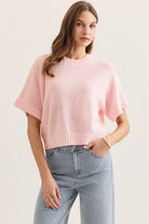 Pink Brianna Spring Knitted Short Sleeve Top by ENTRO, a stylish lightweight sweater for spring, shown on a model.
