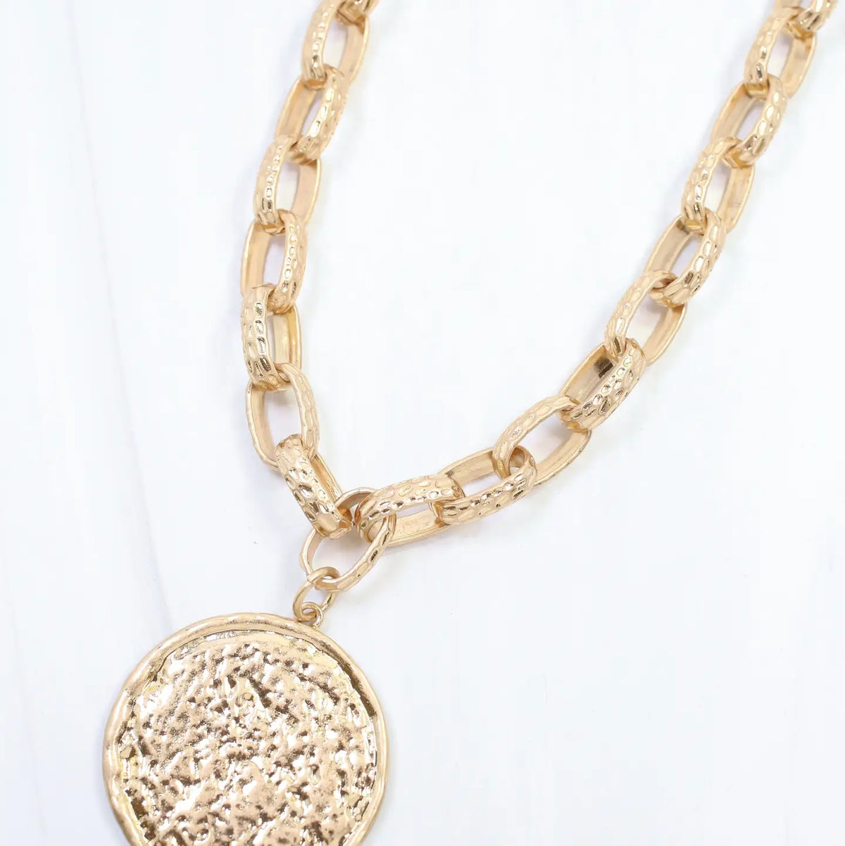 Caroline Hill Newcastle textured medallion necklace featuring a detailed pendant on a chain, stylish jewelry for everyday wear.